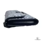 Side profile of Furla wallet on chain showing slim depth and black leather edge