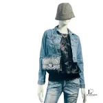 Furla black and white wallet on chain worn crossbody with a denim jacket