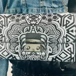 Close-up of symmetrical black and white mandala-style print on Furla leather wallet