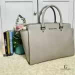 Michael Kors Selma grey Saffiano satchel, styled on a shelf