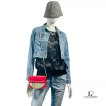 Furla red suede and leather clutch with gold-tone chain, worn crossbody on a mannequin with a denim jacket