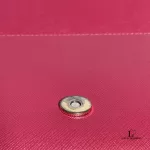 Tory Burch coral pink leather clutch with gold-tone chain, close-up of the clasp and pink lining