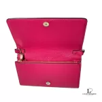Tory Burch coral pink leather clutch with gold-tone chain, opened to show the pink interior