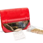 Furla red suede and leather clutch with gold-tone chain, laid out with chain and accessories, second view