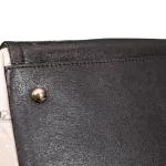 Furla tri-colour two-way handbag in black, white and maroon, close-up of black leather and stud