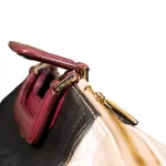 Furla tri-colour two-way handbag in black, white and maroon, top view with maroon handles