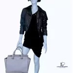 Michael Kors Selma grey Saffiano satchel, styled on a mannequin with a dark jacket