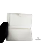 Coach lavender signature monogram billfold wallet, opened to show the inner compartments