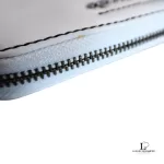 Marc by Marc Jacobs white leather zip-around long wallet, close-up of zip edge