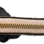 Tory Burch floral long zip wallet with pink panel, close-up of gold-tone zip
