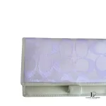 Coach lavender signature monogram billfold wallet, close-up of the signature monogram