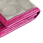 Coach signature monogram flap wallet with fuchsia trim, close-up of the monogram and fuchsia trim