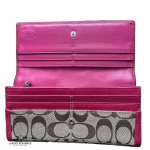 Coach signature monogram flap wallet with fuchsia trim, flap opened