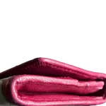 Coach signature monogram flap wallet with fuchsia trim, folded edge and side view