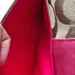 Coach signature monogram flap wallet with fuchsia trim, interior card slots