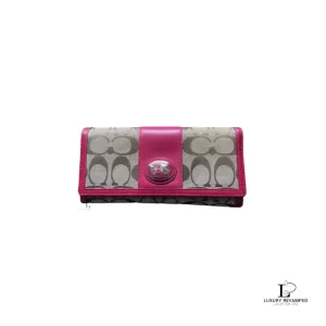 Pre-loved Coach signature monogram flap wallet with fuchsia trim, front view – secondhand designer, NZ