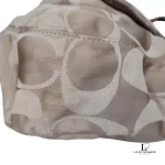 Coach Kristin signature hobo bag with salmon pink leather trim, close-up of the signature C fabric
