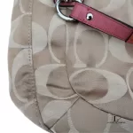 Coach Kristin signature hobo bag with salmon pink leather trim, close-up of the signature C fabric