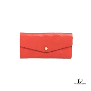 Pre-loved Louis Vuitton Monogram Amplant Empreinte red orange long wallet M60302, front view – secondhand designer, NZ