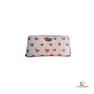 Pre-loved Coach red and cream heart-print PVC full zip long wallet, front view – secondhand designer, NZ