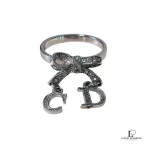 Pre-loved Christian Dior CD initials bow silver ring, size 5, front view – secondhand designer, NZ