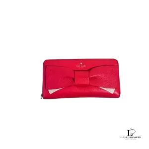 Pre-loved Kate Spade Bow pinkish red leather long zippy wallet, front view – secondhand designer, NZ