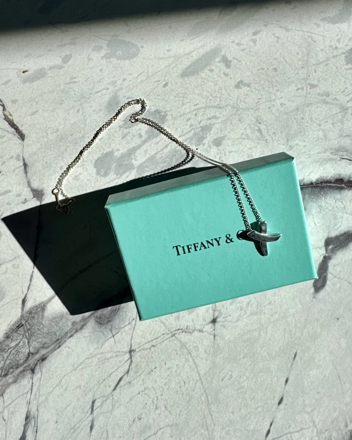 Tiffany & Co. necklace and gift box on marble