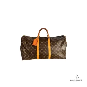 Pre-loved Louis Vuitton Monogram Bandouliere 55 travel bag with shoulder strap and padlock with key, front view – secondhand designer, NZ