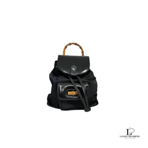 Pre-loved Gucci black nylon and patent leather backpack with bamboo handle, front view – secondhand designer, NZ