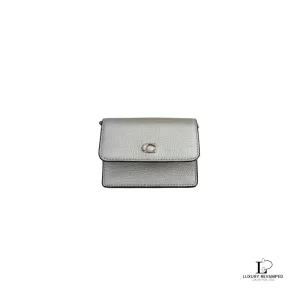Pre-loved Coach mini crossgrain leather wallet in matte gold with removable chain, front view – secondhand designer, NZ