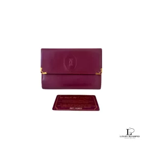 Pre-loved Must de Cartier bordeaux leather medium bifold wallet with gold-tone hardware, front view – secondhand designer, NZ