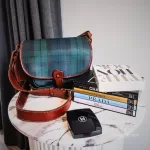 Pre-loved vintage Ralph Lauren tan, green and blue checkered canvas and leather saddle crossbody bag, front view – secondhand designer, NZ