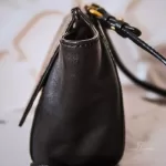MCM black leather crossbody bag with scale-like flap and gold logo, view 4