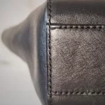 MCM black leather crossbody bag with scale-like flap and gold logo, view 7