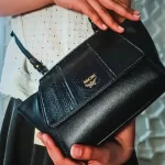 MCM black leather crossbody bag with scale-like flap and gold logo, view 26