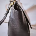 MCM black leather crossbody bag with scale-like flap and gold logo, view 5