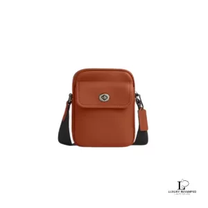 Pre-loved Coach brown smooth grain leather turnlock crossbody bag, new with tag, front view – secondhand designer, NZ