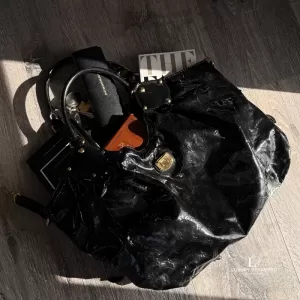Pre-loved Louis Vuitton Limited Edition Mahina Surya XL black perforated patent leather hobo bag M95796, front view – secondhand designer, NZ