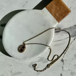 Pre-loved Christian Dior oval 'CD' gold-tone pendant necklace, front view – secondhand designer, NZ
