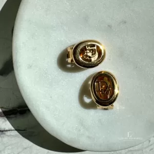 Pre-loved Christian Dior oval 'Dior' gold-tone clip-on earrings, front view – secondhand designer, NZ