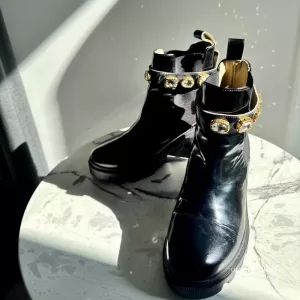 Pre-loved Gucci Trip black patent leather ankle boots with detachable crystal ankle straps, front view – secondhand designer, NZ